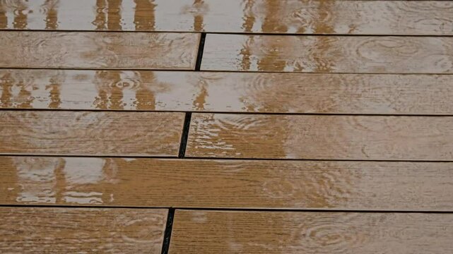 Rain on the wooden floor surface.