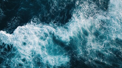 Fototapeta premium Aerial view showcases turbulent ocean water and foamy white waves