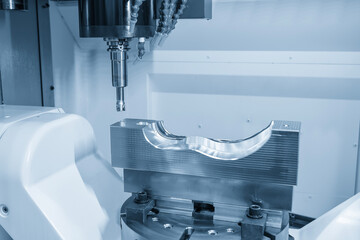 The CNC milling machine rough cutting the injection mold parts by indexable tools in the light blue scene.