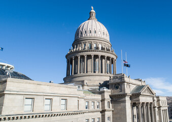 The Capitol building is a large, gray structure with a dome on top