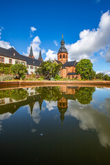 A historic monastery in the morning. Monastery walls, church and buildings are reflected in the...