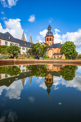 A historic monastery in the morning. Monastery walls, church and buildings are reflected in the...