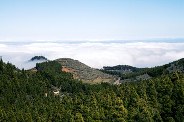 Obraz premium A beautiful view from the top of the mountains, above the clouds. A road stretching along the top of the mountains