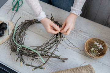 DIY process of woman making candid Easter wreath arrangement decor. Small business, self employed...