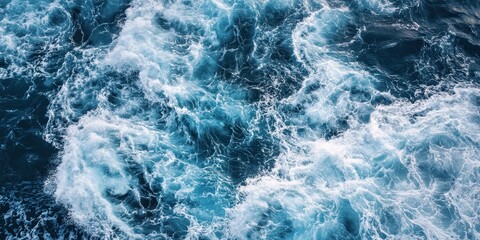 Obraz premium Turbulent ocean waters crashing and foaming in an aerial view
