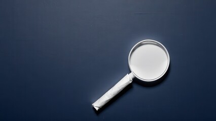  a magnifying glass rests on a dark surface