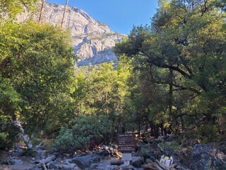 A trail sign with mileages for Yosemite Falls in Yosemite National Park, California