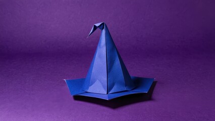 Fototapeta premium a whimsical origami wizard hat stands proudly against a rich purple backdrop