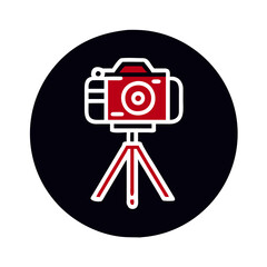 Camera on tripod against a black background