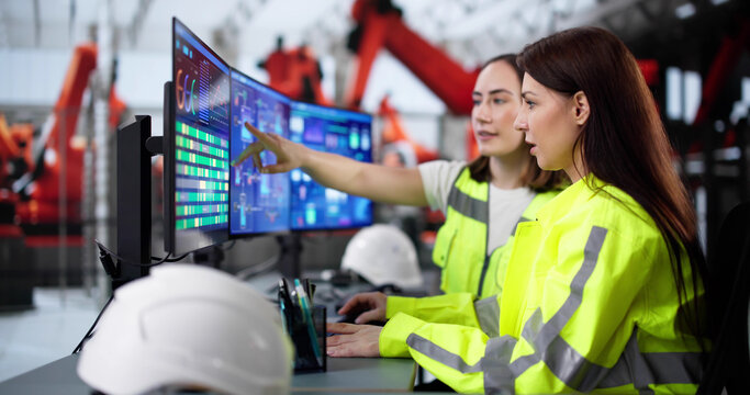 Female engineer developing automated manufacturing system at modern factory