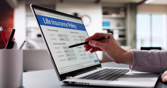 Woman filling out life insurance policy application form on laptop computer