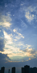 Beautiful sunset reflecting the colorful sky and silhouettes of clouds