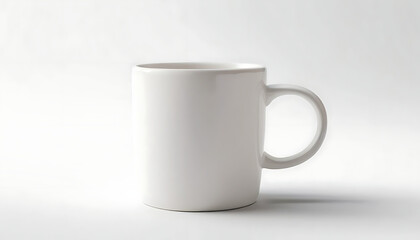 Fototapeta premium Plain white ceramic mug on a white background. Perfect for mockups, branding projects, coffee shop graphics, or minimalistic designs.