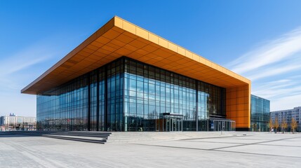 Modern architecture with glass facade and yellow roof under a blue sky. Contemporary building design.