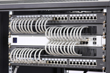 An Ethernet data switch connected to patch panels using patchcords. Installed in a...