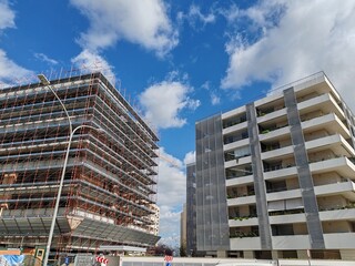 Rome, Italy - 27 February 2025, two large social housing buildings, one under construction, the other completed, in the Laurentina district.