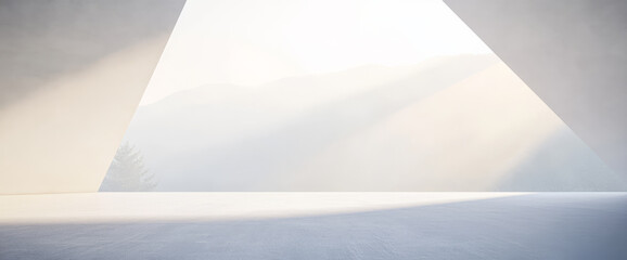 Ground-level view of an open space with light pouring through a triangular structure