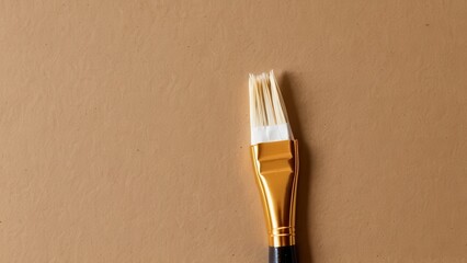  A solitary paintbrush rests on a warm