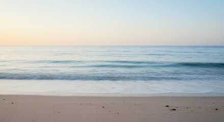 Gentle Ocean Waves Lapping on Sandy Beach at Sunrise Light