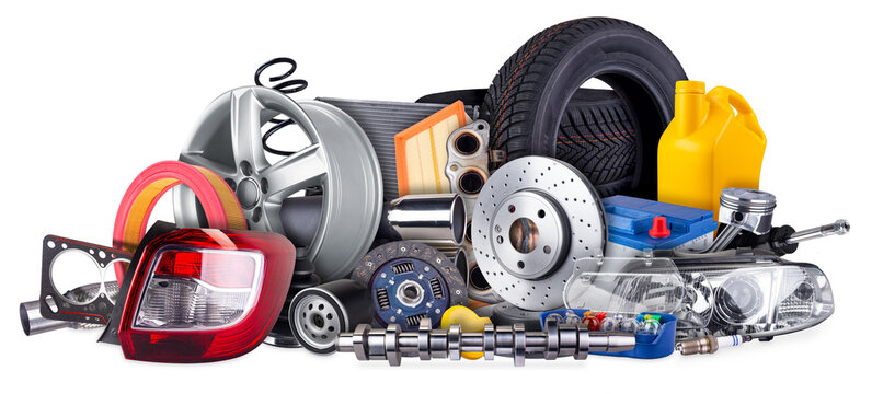 huge stack pile of  car parts including wheels, tires, filters, and engine components isolated  white background. automotive vehicle repair and service industry concept.
