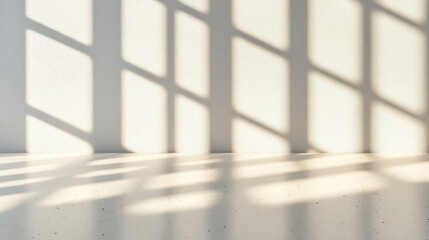 Naklejka premium serene interior space with soft shadows cast on light colored wall and floor, creating calming atmosphere. interplay of light and shadow adds depth and texture to scene