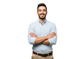 A young man wearing a light blue button-up shirt and beige pants standing with arms crossed and smiling confidently