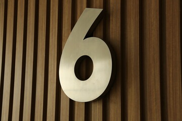 Modern Metal Number Six on Wood Paneling