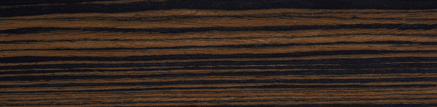 Contrasting waves of coffee and noir dance across this striking macassar ebony veneer, a testament to nature's artistry