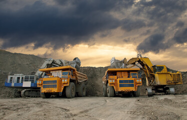 Industrial excavators loading ore into big yellow trucks of quarry. Open pit mining industry. No AI tools