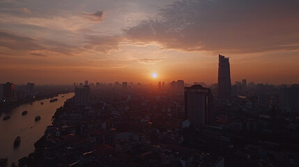 Naklejka premium Stunning cityscape sunset view with orange sky and river urban light aerial golden modern travel