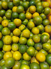 Top-down view of a neatly stacked display of fresh juice oranges. Bright and juicy citrus fruits arranged in an organized pattern, highlighting their vibrant orange color and smooth texture.