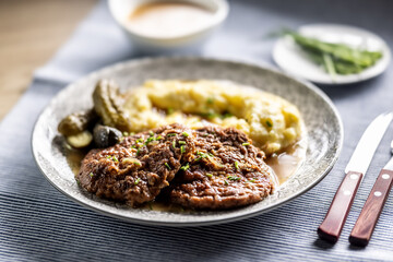 Inverted Beef Schnitzel with Mashed Potatoes and Pickled Cucumbers. Traditional Czech and Slovak Food