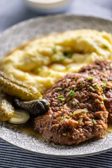 Inverted Beef Schnitzel with Mashed Potatoes and Pickled Cucumbers. Traditional Czech and Slovak Food