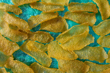 Manihot Esculenta (Cassava Chips) Drying on Blue Tarp Under Sunlight in Traditional Village