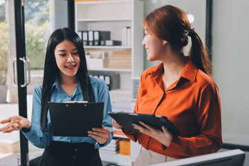 Entrepreneurs and business people conference in modern meeting room, happy multiracial coworkers have fun cooperating working together at office meeting, asian teamwork concept