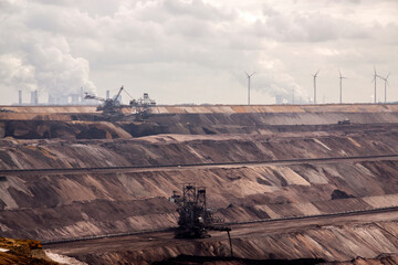 Germany, North Rhine Westphalia, -june 2017:  ground excavator in action moving mullock and soil at open pit coal mine; Germany,for winning brown coal