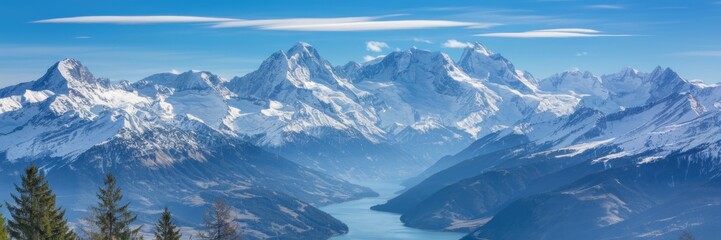 Obraz premium Snowy Alps, where snow-capped peaks stretch as far as the eye can see. In the foreground are green trees and a winding river. A banner with space for the text.