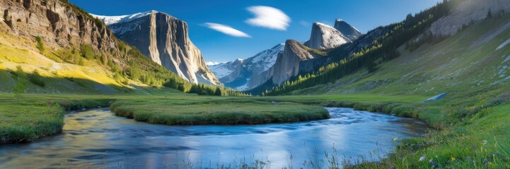 Obraz premium Alpine cliffs and snow-capped mountain peaks in the background. A serene valley covered with green grass. A clear stream flows through the valley. A banner with space for the text.