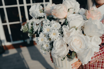 Elegant Floral Arrangement in White and Soft Pink for Wedding or Event Decor Featuring Roses and Daisies in a Vase