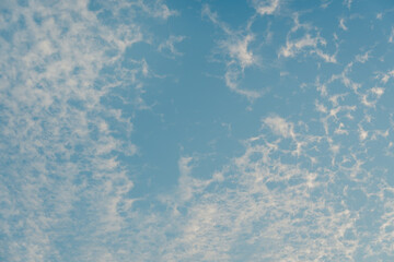 Serene Sky with Wispy Clouds Illuminated by Soft Natural Light, Perfect for Tranquil Background or Nature-Themed Designs