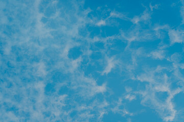 Expansive Blue Sky with Soft White Clouds Creating a Serene and Peaceful Atmosphere for Outdoor Scenes and Backgrounds