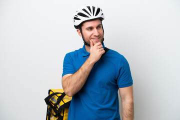 Young caucasian man with thermal backpack isolated on white background looking to the side