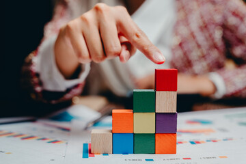 Person Using Colorful Building Blocks for Business Growth Representation, Business concept