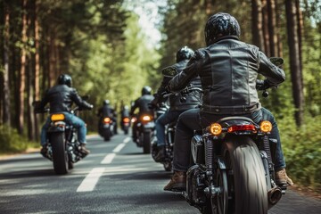 Naklejka premium A group of men in leather jackets rides their motorcycles along a winding road surrounded by tall trees under clear blue skies