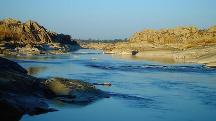 Fototapeta premium Serene River Flowing Through Rocky Landscape