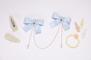 Different hair accessories on light background, flat lay