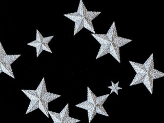 Obraz premium Glittering Silver Stars Against a Luxurious Black Velvet Background