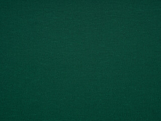 A close-up shot captures the sophisticated simplicity of a dark green paper surface with inviting texture and depth