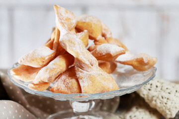Fat Thursday celebration - traditional Angel Wings cookies decorated with powdered sugar.
