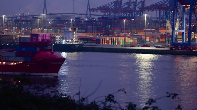 HAMBURG, GERMANY - Feb 28th, 2025: 4k - Containership "Frederik" is leaving the Hamburg harbor in the evening